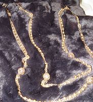 Photo of vintage three strand gold and pearl necklace showing gold filigree ball beads and pearl beads on gold chain, measuring 28 inches.
