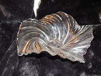 Top front angle showing the wave swirl pattern and curved naturalistic shape of the clear crystal Mikasa Belle Epoque bowl.