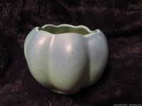Side view of one turquoise/green matte Van Briggle gourd squash mini pot showing shape and glaze color.