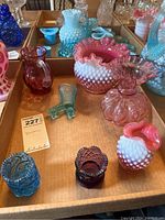 Photo showing collection of various small art glass vases and figurines including Fenton hobnail ruffle vases, purple pitcher, boot figurine and others.