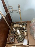 Overall view of box including powder horn, lighters, candleholder, compass, and other assorted items.