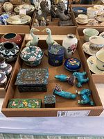 Photo showing assortment of trinket boxes, duck figurines, bird figurines, vase, and various bowls arranged in a tray.