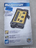 Mastercraft 8-outlet power bar in original packaging showing product image and key features