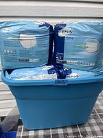 9 packs of TENA Extra fully breathable underwear in blue container