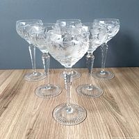 Wide angled photo showing all 6 clear crystal Nachtmann Traube wine hocks arranged in a circle.