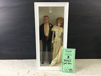 Vintage Barbie and Ken dolls in white display case showing full bodies