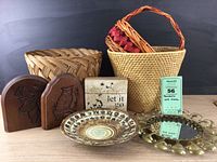 Full view of all items: 3 woven baskets, wooden bookends, pottery bowl, decorative box, brass-finish mirror and tray.