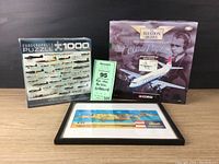 Wide shot of the lot showing the boxed Eurographics WWII Aircraft puzzle, boxed Corgi Vickers Viscount 806 model, framed aviation print, and an auction lot card.