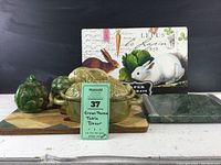 Entire lot arranged on shelf with rabbit terrine, artichokes, table mats, and cheese board