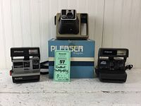 Photo showing all three instant cameras: Polaroid Sun 600, Kodak Pleaser (with original box), and Polaroid One Step.