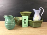 All five pottery pieces grouped showing colors, shapes and styles