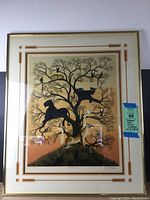 Full view of the framed print showing African animals in a tree with sunset background and gold frame.