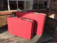 Pair of vintage pink Sears suitcases, side by side, showing overall size and color.