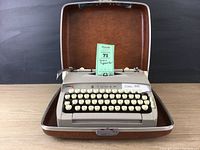 Vintage Sears Tower Citation 88 manual typewriter inside open brown hard case.