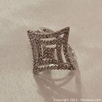 Front view of 10K white gold dinner ring showing concentric square openwork top with pave-set diamonds