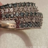 Close-up of top surface showing five staggered rows of alternating clear and dark round stones