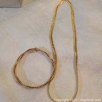 Necklace and bracelet laid out on white cloth