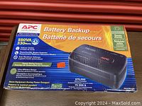 Front view of the box showing APC branding, model specifications and features including 550VA and 330 Watt capacity.