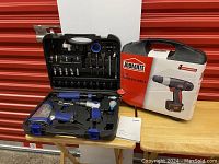 JOBMATE 12V cordless drill in its original box alongside Hyundai pneumatic tool set in open hard case showing tools.