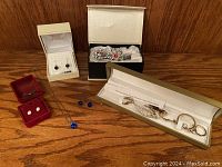 Full display of jewelry pieces is shown including earrings, necklaces, bracelet, and brooches with Swarovski crystals.