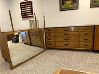Full room view showing dresser and large framed mirror leaning against wall