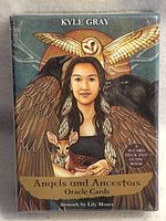 Front of sealed box showing the title, artist, and artwork featuring a woman with animal symbols.