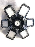 Top view showing six foldable LED panels with numerous small LED diodes arranged on each panel.