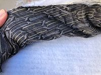 Close-up showing the black Quibble fabric texture and pattern