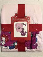 Photo of folded pajama set with packaging showing graphic of set with cats in Christmas hats and included eye mask.