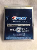 Front of new sealed Crest 3D Whitestrips Supreme Bright box showing product name, levels whiter (28), and quantity (42 strips, 21 treatments).