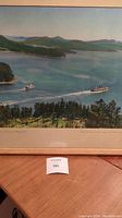 Overall photo of framed print showing two steamship ferries sailing on calm coastal waters, surrounded by trees and islands.
