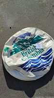 Front view of the spare tire cover with British Columbia mountain and ocean graphic and text.