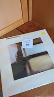 Front view of sealed Dire Straits vinyl album showing cover artwork and original shrink wrap.