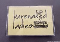 Front cover of cassette case showing yellow insert with Barenaked Ladies logo and sandwich drawing.