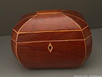 Front and side view of the wooden jewelry box showing the keyhole and inlay detail