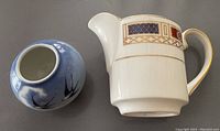 Two porcelain items, a creamer and a small globe vase, shown from above to display shape and top opening.
