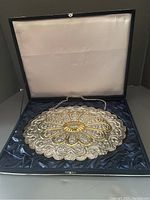 Turkish sterling silver repoussé wedding mirror displayed inside a fitted case with hanging chain.