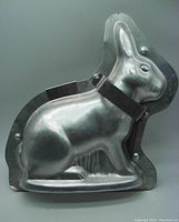 Front view of one half of the vintage 3D Easter bunny cake/chocolate mold showing detailed rabbit shape and hinge clasps.