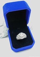 Silverplated vintage ring with raised Harvey Ball smiley face design, displayed inside a royal blue velvet box.