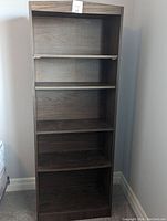 Front view of the 5-shelf bookcase showing all shelves and wood grain finish.