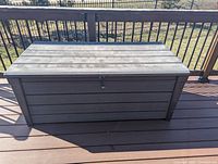 Closed front exterior view showing latch and woodgrain texture