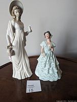 Photo of both figurines on a wooden surface showing overall size and appearance.