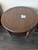 Top view of the round solid wood side table showing wood grain and inset border detail.