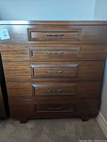 Front view of the Gibbard mid-century modern tall boy dresser showing five wooden drawers with brass-style handles.