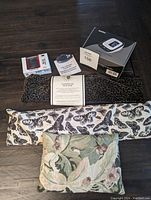 Overview of wellness items including blood pressure monitor, step and cycle counters, and three heatable neck wraps with assorted covers.