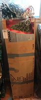 Full boxed unopened NOMA Christmas tree box upright showing product info and image of artificial pine tree 6.5ft tall.