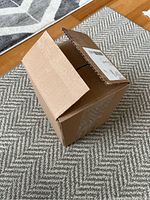 Closed cardboard box presumably containing vinyl records.