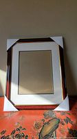 Front view of the new, unused decorative photo frame with protective white corner guards