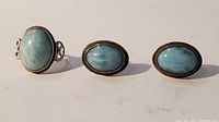 Front view showing one silver ring with oval larimar stone and a pair of larimar earrings.