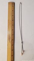 Shows full length of sterling silver necklace next to a ruler measuring approx. 8 inches.